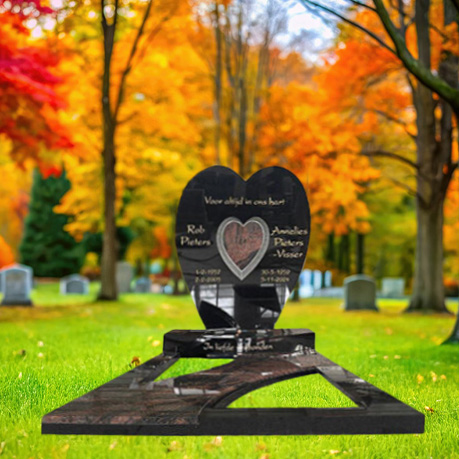 "Polished black granite upright headstone with Aurora Red granite accents and full-length ledger cover in sculptural monument configuration."