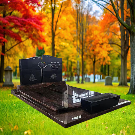 "Polished black granite upright headstone with sculpted floral heart and full-length ledger—crafted as a full monument without kerbset."