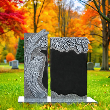 "Black granite upright headstone memorial with carved owl, foliage detail, polished inscription panel, and rectangular base—symbolizing wisdom and spiritual tribute."