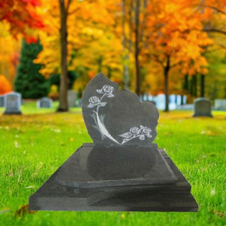 "Charcoal grey granite upright memorial monument with semi-heart floral carvings and polished full-length ledger slab."