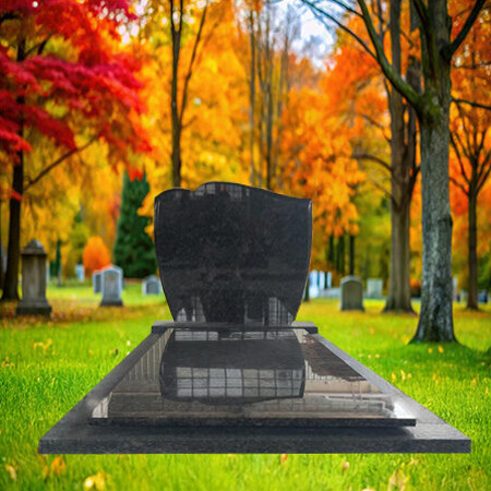 "Hand-carved dark grey granite upright headstone with curved top and matching full-length ledger slab in traditional two-piece monument format"