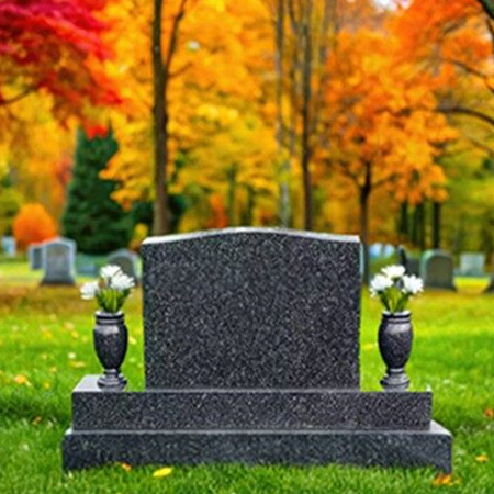 "Polished granite upright headstone with tiered base and matching side vases—crafted for floral tribute and architectural balance."