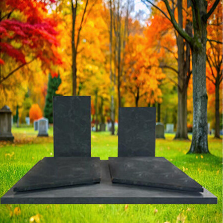 "Grey granite double upright headstones with full ledger slabs, leather-textured finish, and green veining in companion memorial configuration."