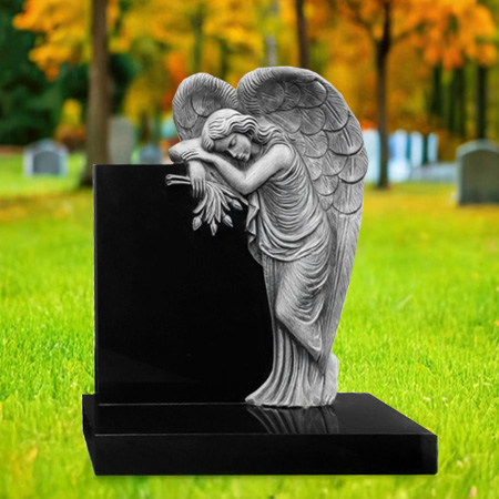 "Polished black granite upright headstone with sculpted angel leaning against the monument face, set on a rectangular granite base in a peaceful autumn cemetery scene."