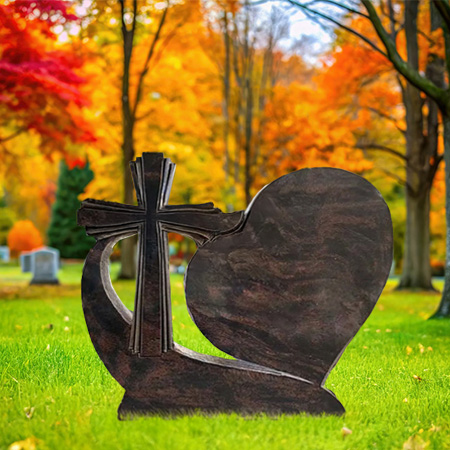 "Polished brown granite upright headstone memorial with carved cross and heart motif, anchored on a solid base—symbolizing devotion and remembrance."