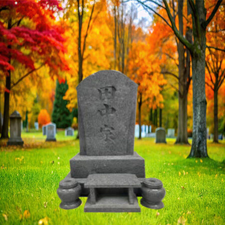 "Polished Japanese grey granite headstone memorial with central pillar (中央墓石) and recessed inscription panel—set in formal cemetery."