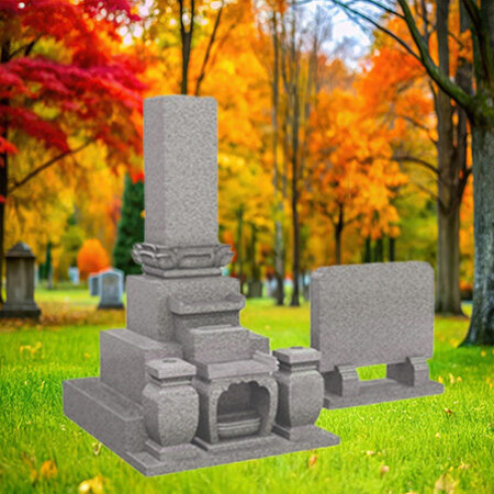 "Japanese grey granite headstone with 三基構成 three-pillar formation, flower holder 花立て, and incense stand 線香立て for traditional offerings."