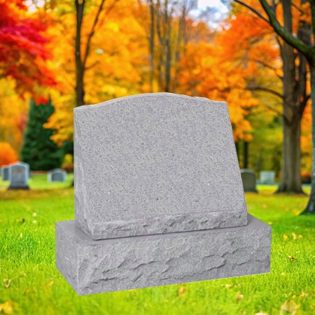 "Light gray granite slant-style upright headstone with polished face and chiseled edge finishes, mounted on a granite base in an autumn cemetery setting."