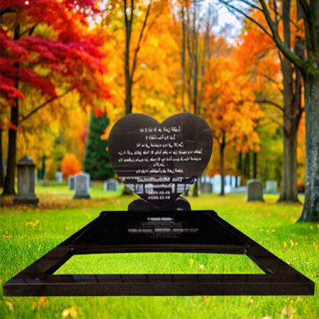 "Heart-shaped polished black granite upright headstone with partial base-mounted ledger slab"