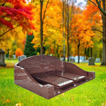 "Polished red granite upright headstone with two matching ledger covers inset into a granite kerb base—forming a split-cover framed monument for complete grave coverage."