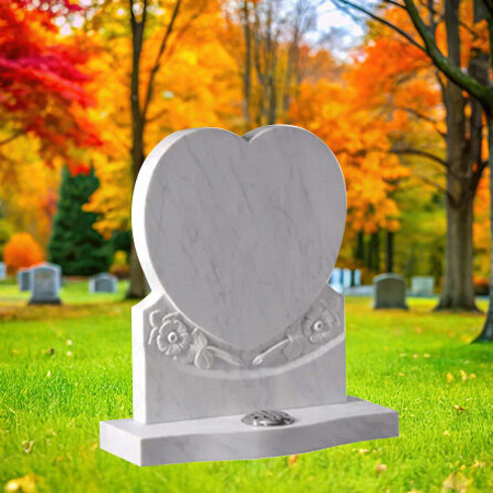 "White marble upright heart-shaped headstone with cascading rose relief and polished inscription panel atop rectangular base—symbolizing purity and love."