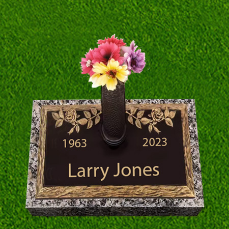 Bronze pillow flush grass marker with central vase, botanical carvings, engraved name and dates, and granite border.
