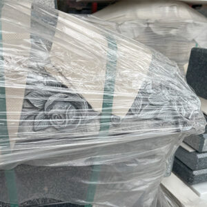 "Large wooden crate with white protective covering and export label, used for shipping ELHASG memorials, sculptures, and stone slabs internationally."