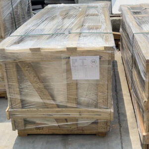 "Large wooden crate with CE-certified white stone slabs wrapped in clear plastic and secured with green straps, staged for international delivery."
