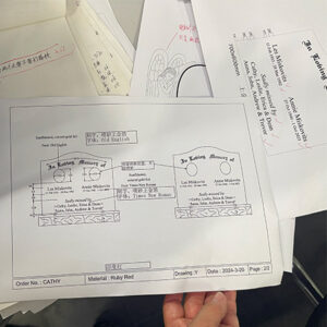 "Hand holding a memorial design sketch with personalized inscriptions, font selections, and layout notes for a double headstone."