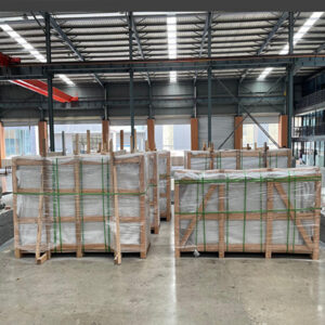 "Upright headstones, ledger monuments, granite and marble slabs, and custom sculptures packed in crates and pallets for international delivery."