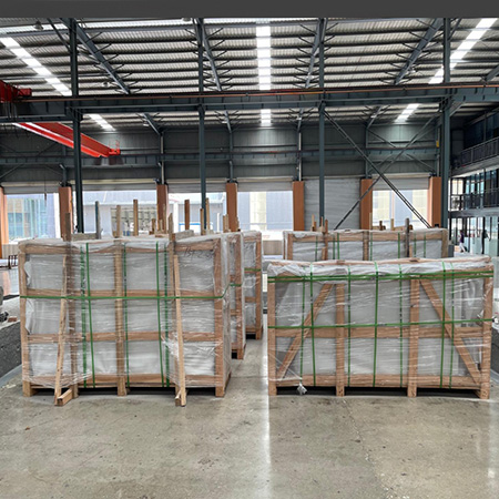 "Upright headstones, ledger monuments, granite and marble slabs, and custom sculptures packed in crates and pallets for international delivery."