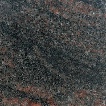 Himalayan Red granite sample with vibrant red hues and speckled texture