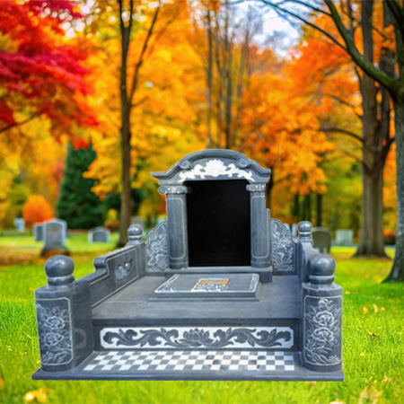 "Gray granite pavilion-style monument with canopy headstone, sculptural columns, checkered platform, and ornate carvings."