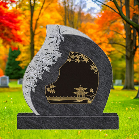 "Artistic granite upright headstone with engraved maple leaves and pavilion landscape scene, mounted on a matching granite base."