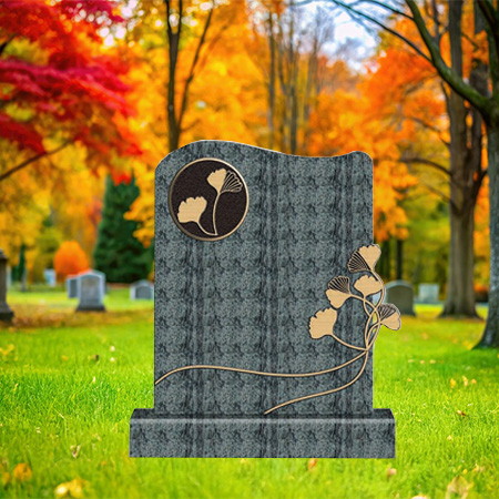 "Textured dark granite upright headstone with circular ginkgo leaf emblem and branch carvings, mounted on a matching granite base."