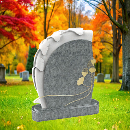 "Polished gray granite upright headstone with carved ginkgo leaves and bronze branch motif, mounted on a matching granite base."