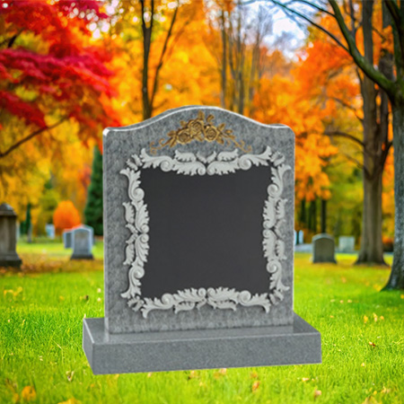 "Polished gray granite upright headstone with ornate carvings, mounted on a matching granite base."