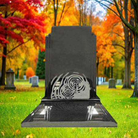"Polished black granite upright headstone with concentric labyrinth carving and tiered granite base."