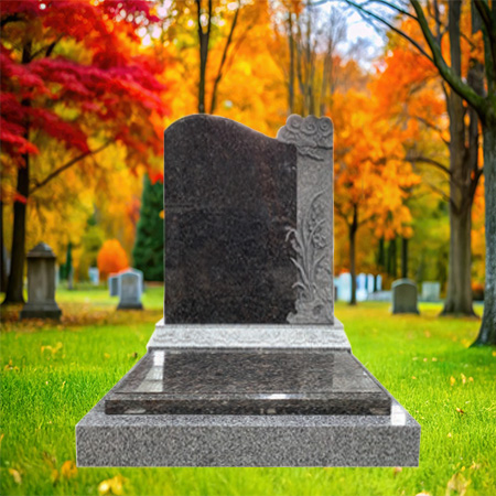 "Polished dark granite upright headstone with floral carvings on the side, mounted on a dual-tone granite base."