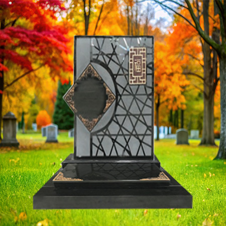 "Polished granite upright headstone with geometric diamond centerpiece and ornamental corner detailing, mounted on a granite base."