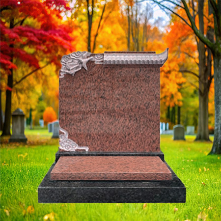 "Polished reddish granite upright headstone with decorative carvings in the corners, mounted on a black granite base."
