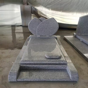 "Grey polished granite upright headstone with overlapping lotus petal design and full-length ledger base with raised accent."