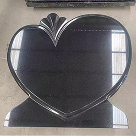 "Heart-shaped polished granite slab with stylized fish tail and fin detail, crafted at Elhasg."