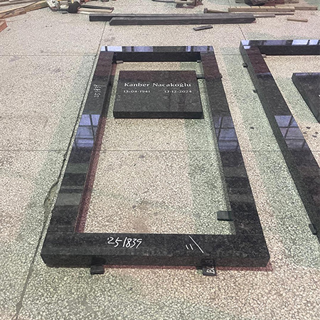 "Flat granite headstone marker with kerb set in Elhasg workshop surrounded by stone slabs and tools."