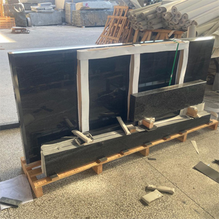 "Polished granite ledger tombstone cover strapped and padded on pallet in Elhasg factory."