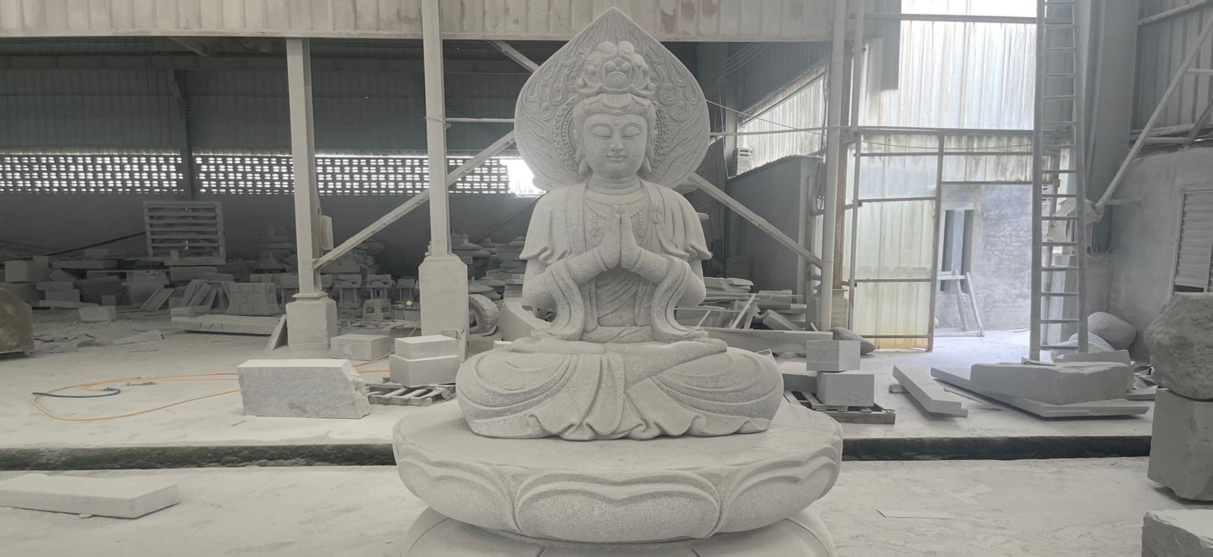 "Indoor circular columbarium with marble flooring, floral centerpiece, and skylight illumination."